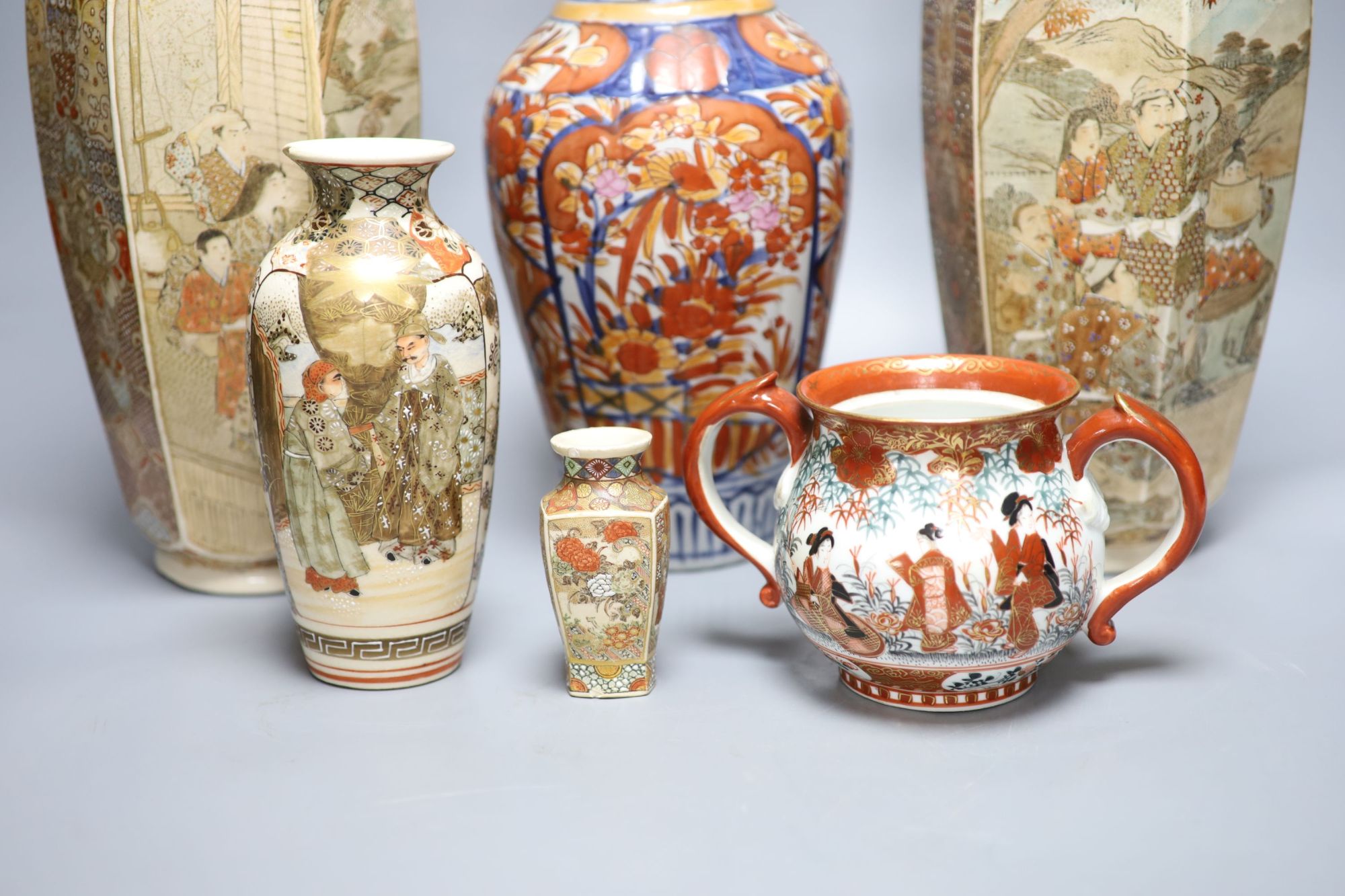 A pair of Japanese Satsuma vases, two others, an Imari vase and a two handled pot, tallest 31cm,